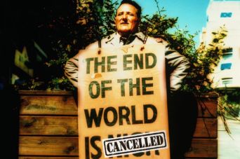 Man wearing sandwich board sign on street. Image Credit: Getty Images/Alan Powdrill